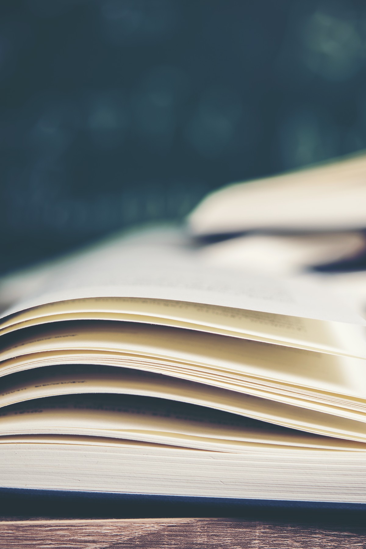 An open book on a wooden desk